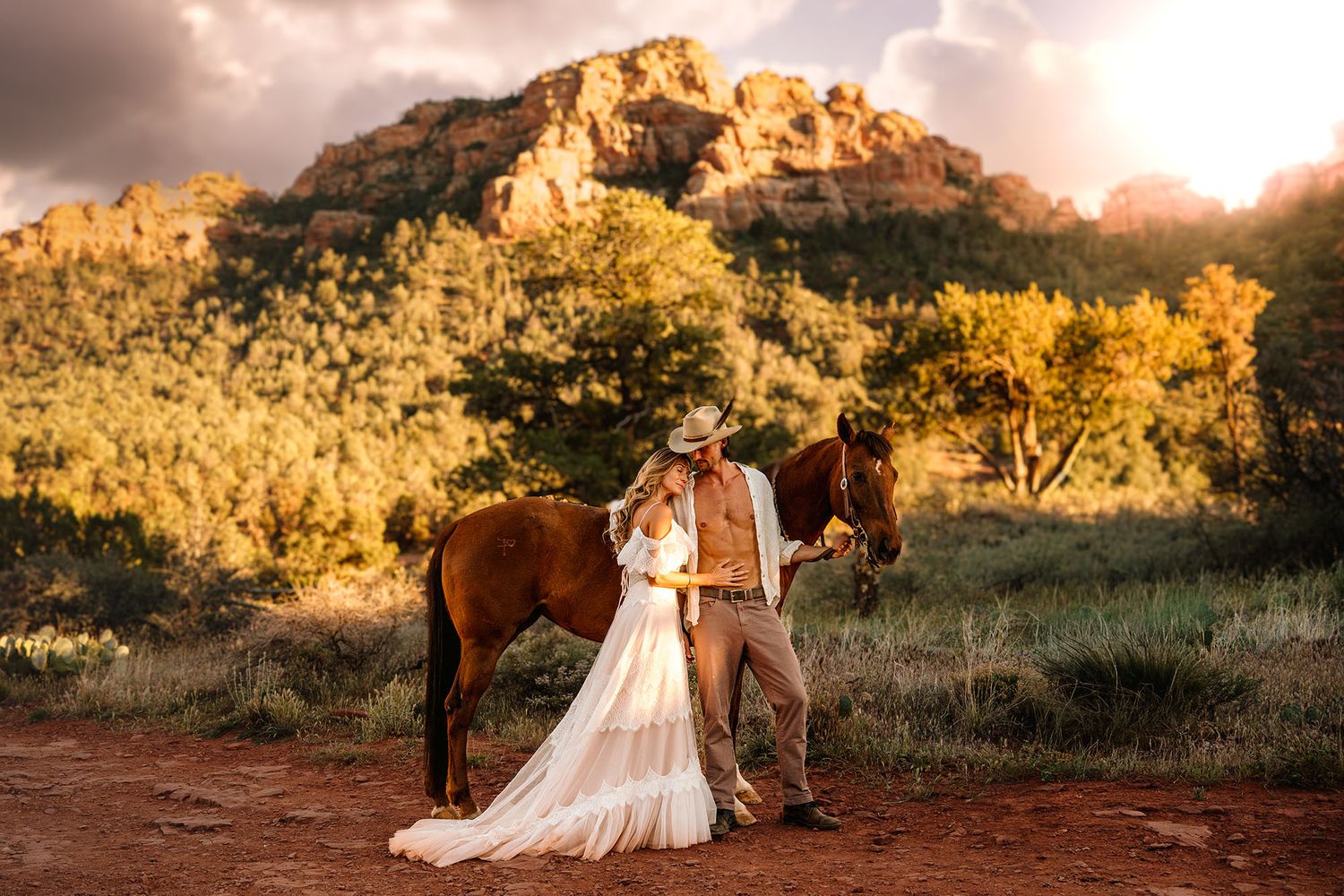 Enchanted lovers pose with a brown horse at golden hour in Sedona, Arizona red rock landscape.