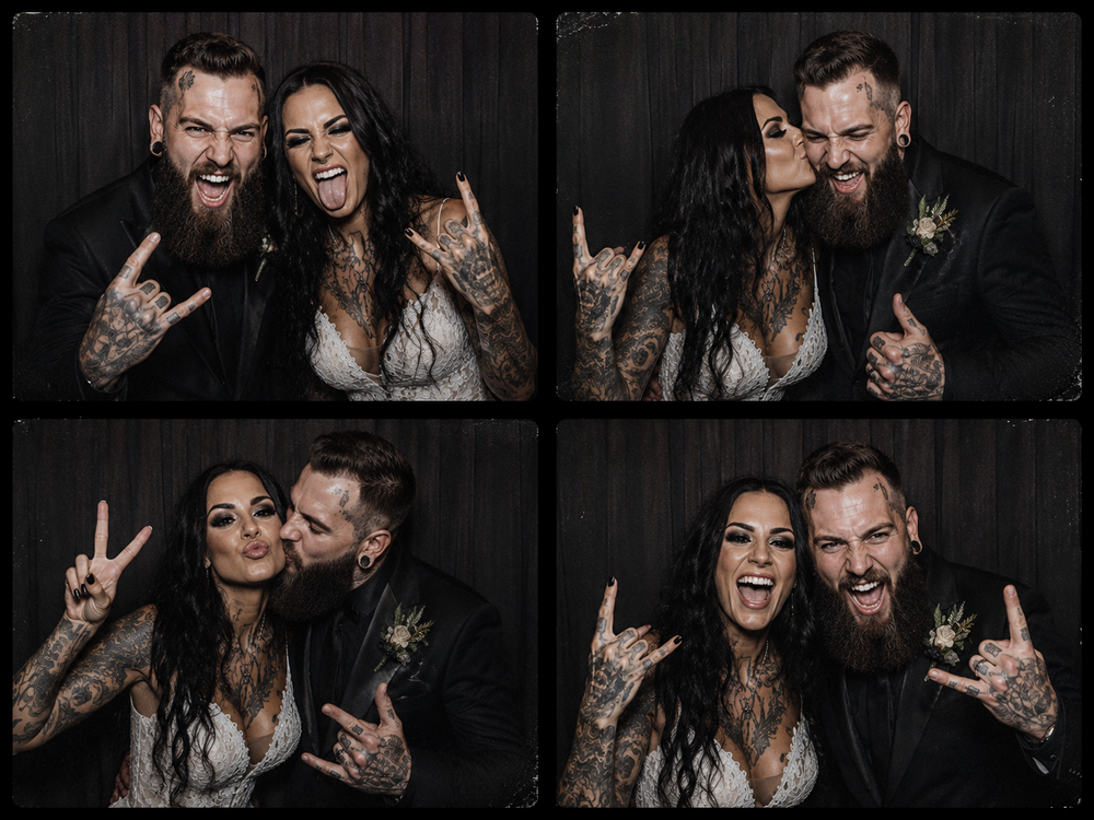Tattooed couple in wedding attire posing playfully in a photo booth strip, making rock and peace signs.