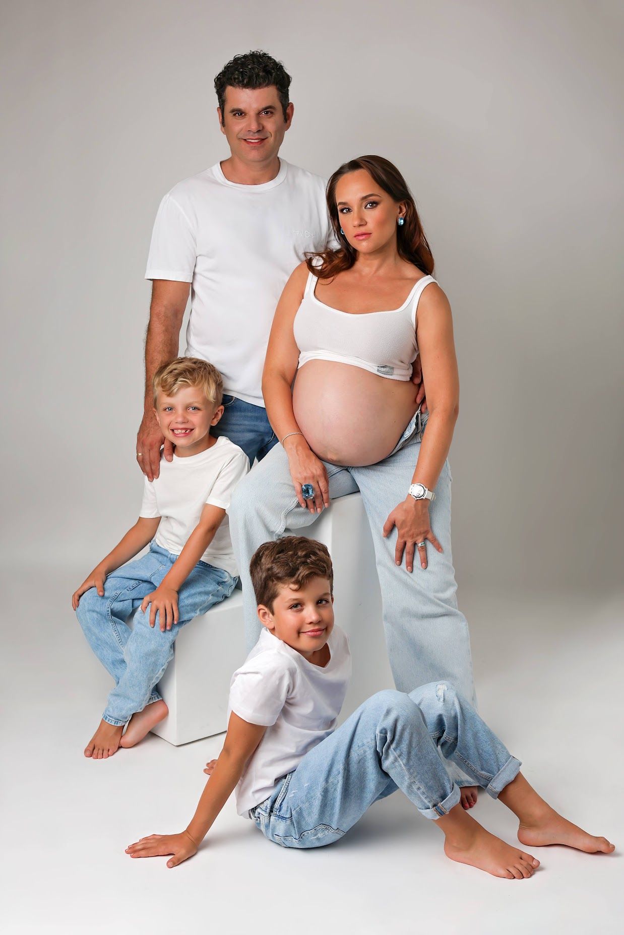 Expecting mother with her family during a studio maternity photography session.