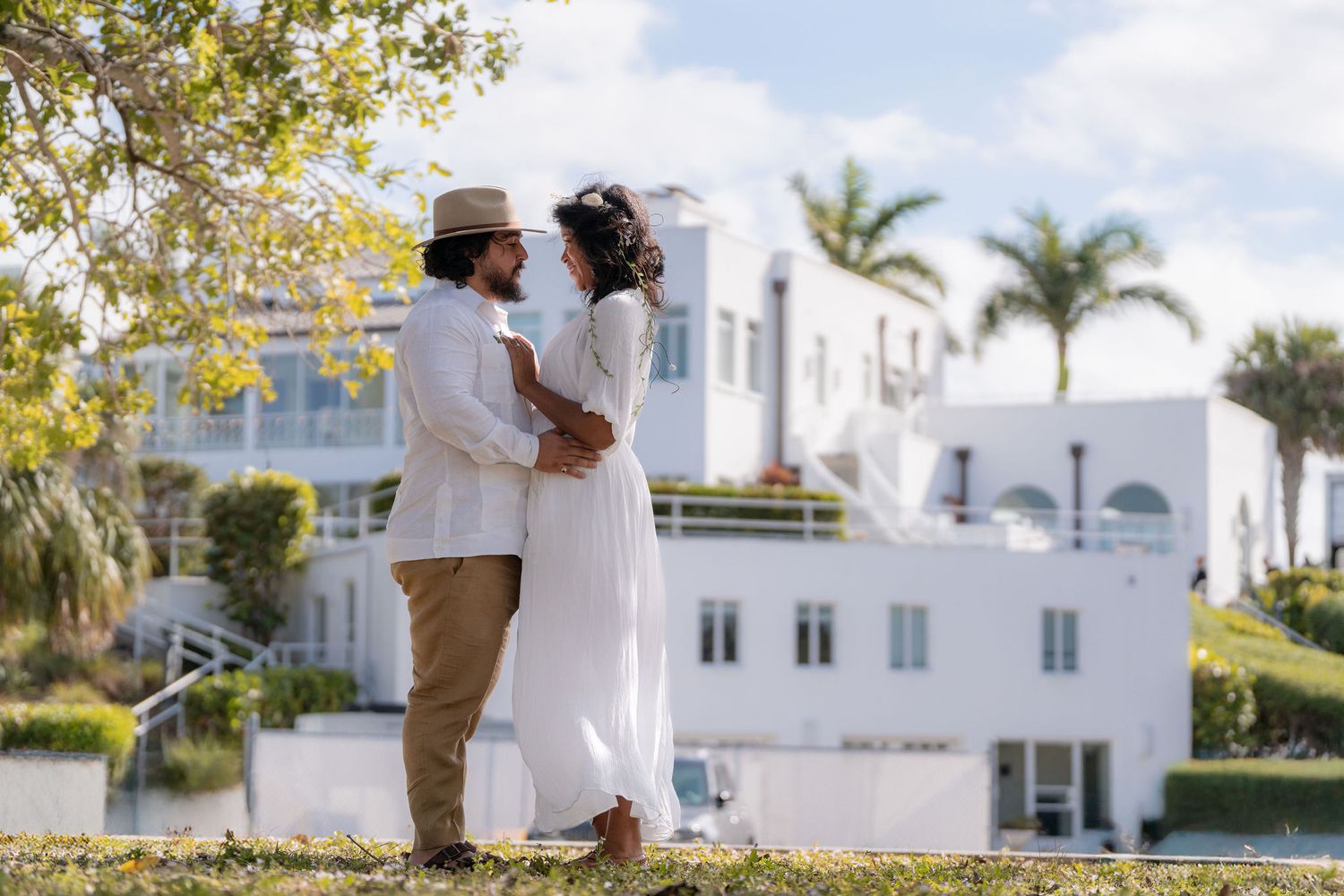 Bride and groom on the lawn below the Mansion at Tuckahoe with the terraced architecture behind them