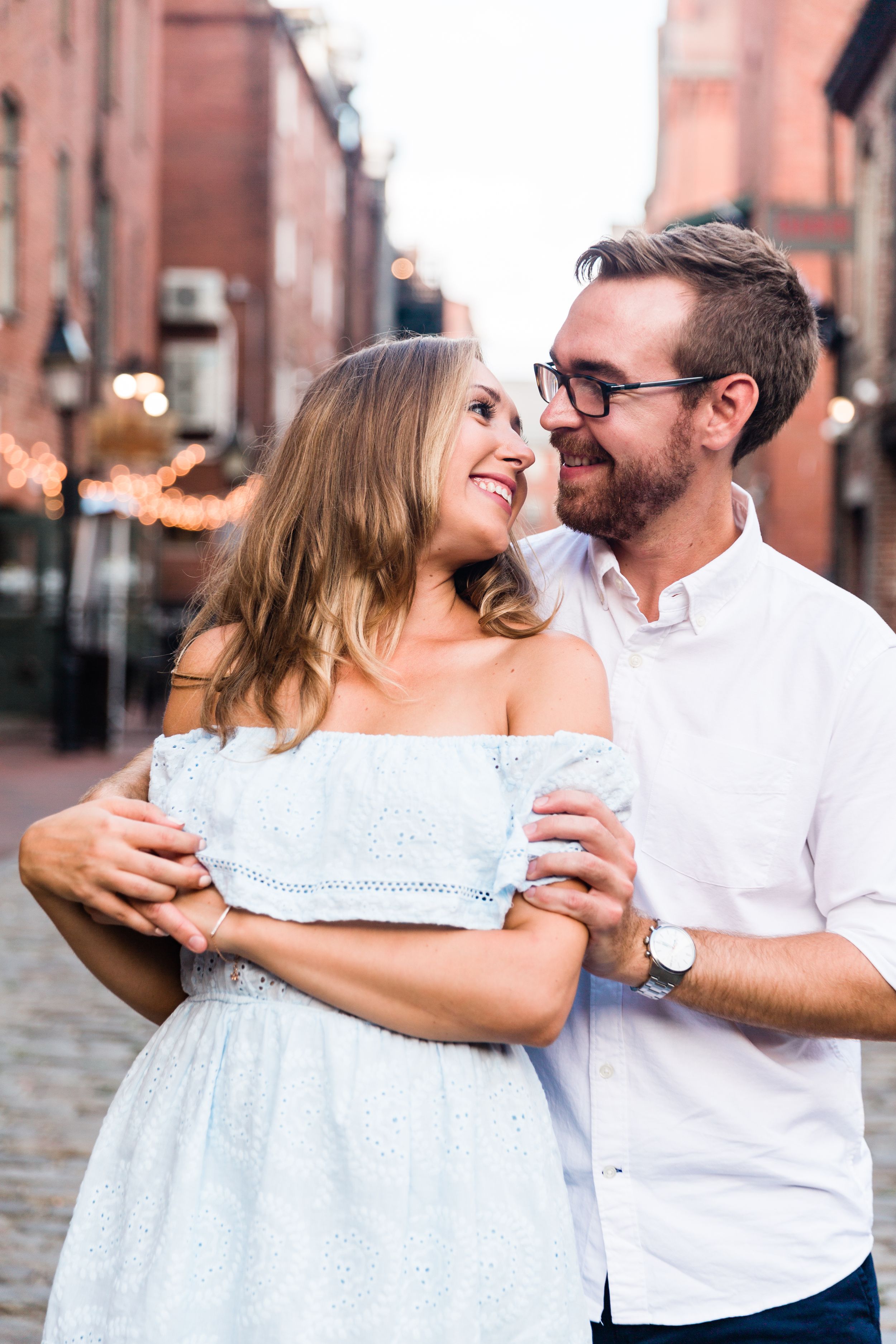 Portland Maine engagement photos on exchange street showing candid moments for save the dates, wedding invitations, and wedding website