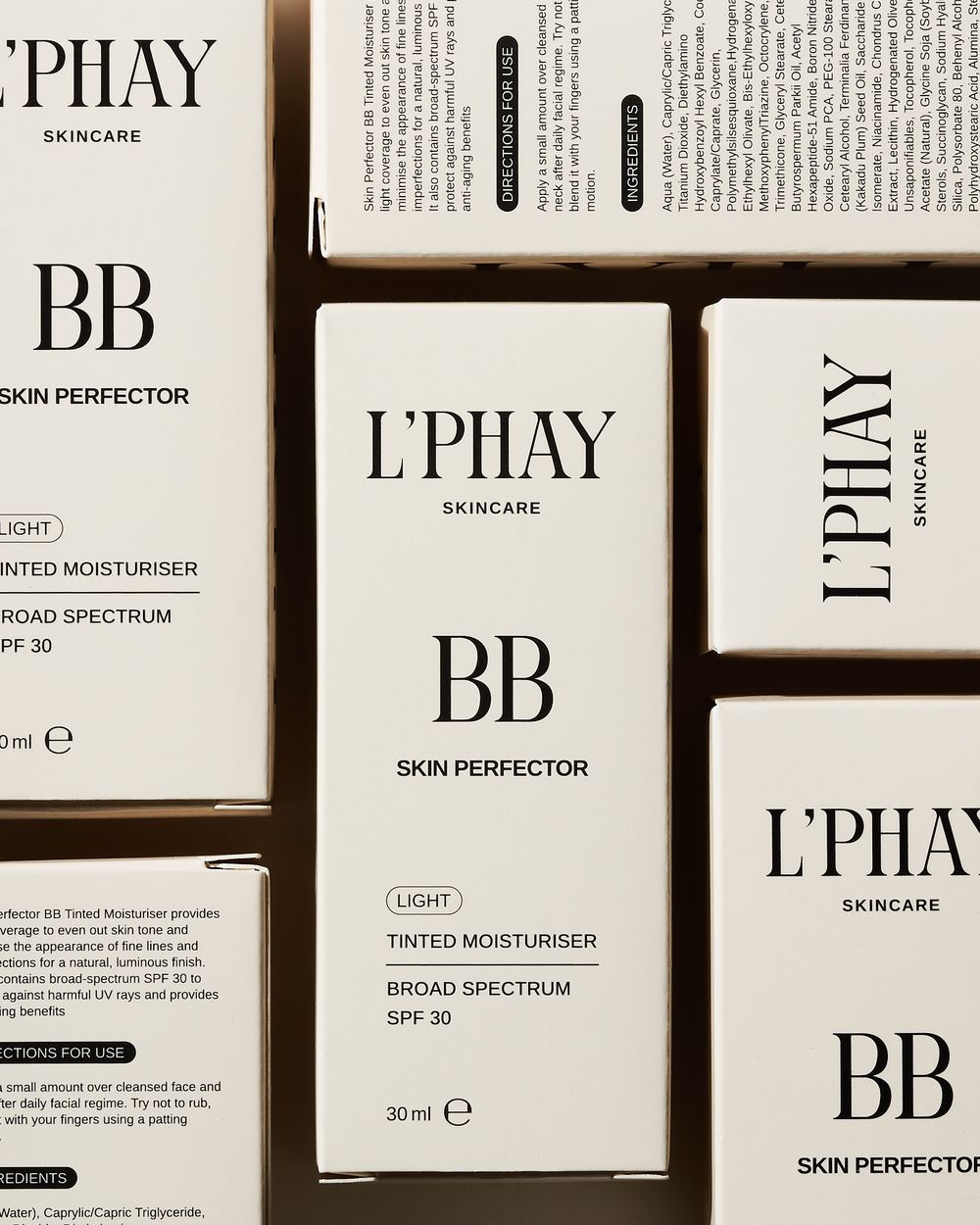 Minimal skincare packaging for L'PHAY BB cream skin perfector with tinted moisturizer and SPF 30 displayed on light background.