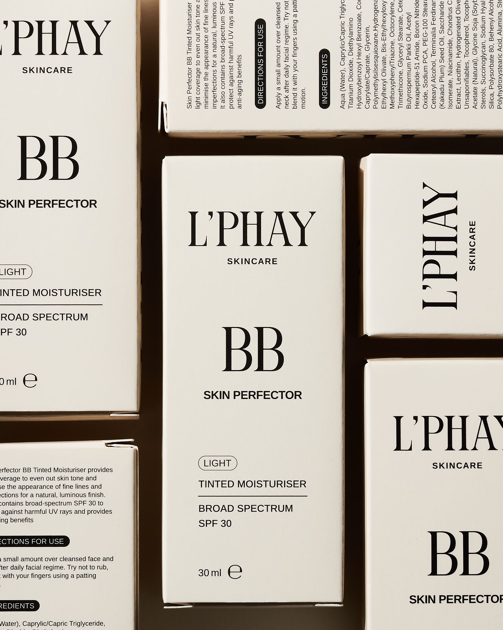 Minimal skincare packaging for L'PHAY BB cream skin perfector with tinted moisturizer and SPF 30 displayed on light background.