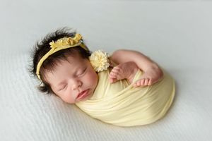 Newborn girl with dark hair in yellow. Greenville, SC newborn photographer, Easley, SC Newborn photographer