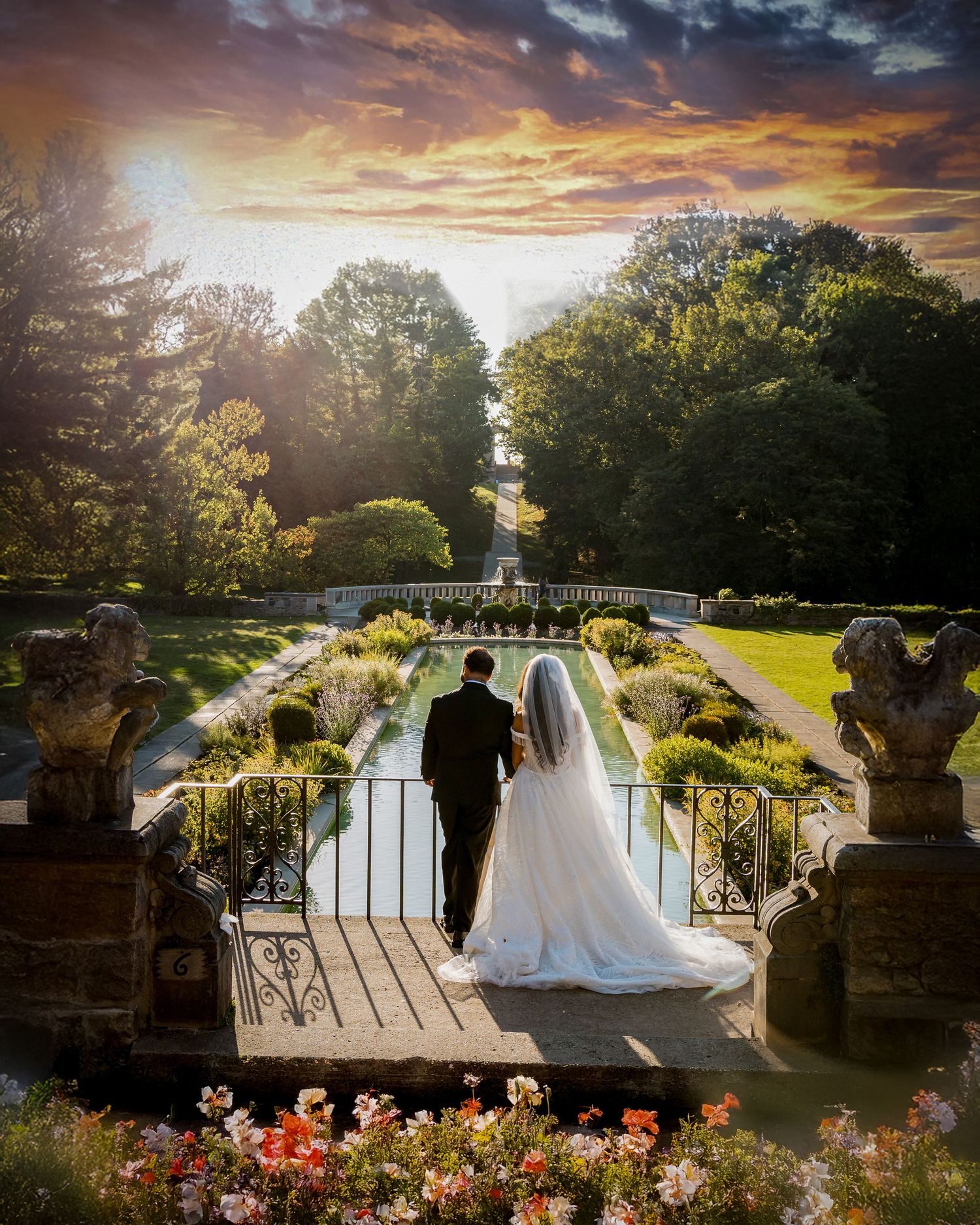 A romantic garden scene with a reflection pool and formal landscaping creates an elegant wedding backdrop.