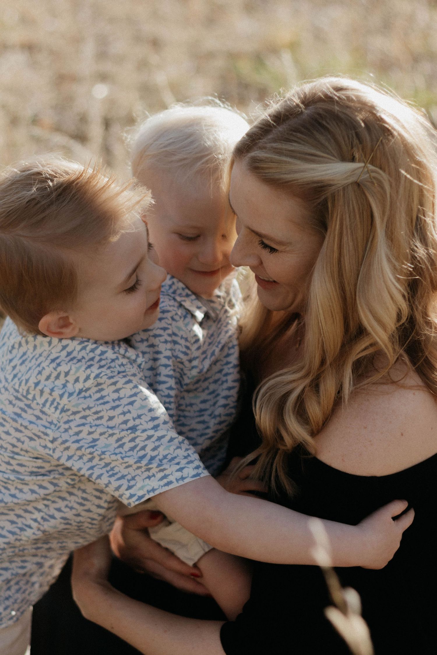 A Mother and children in soft natural light during a golden hour outdoor photo session. Family photoshoot in Colorado