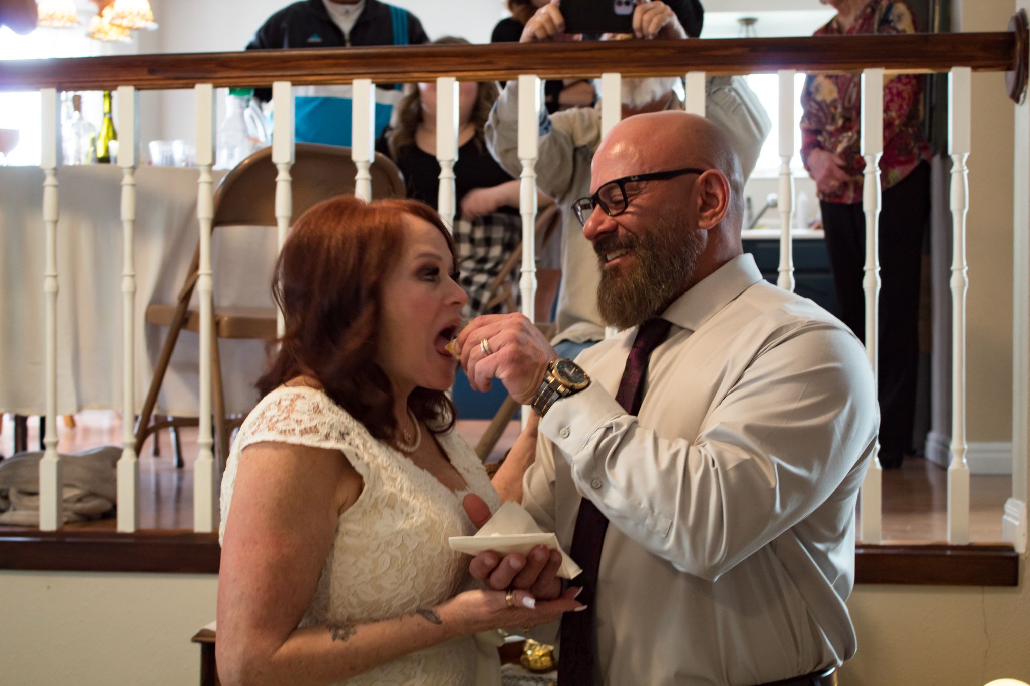 Indoor wedding reception scene with guests mingling.