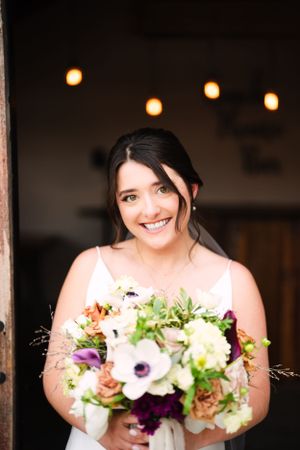 Beautiful bouquet with purple and white flowers against dark background.