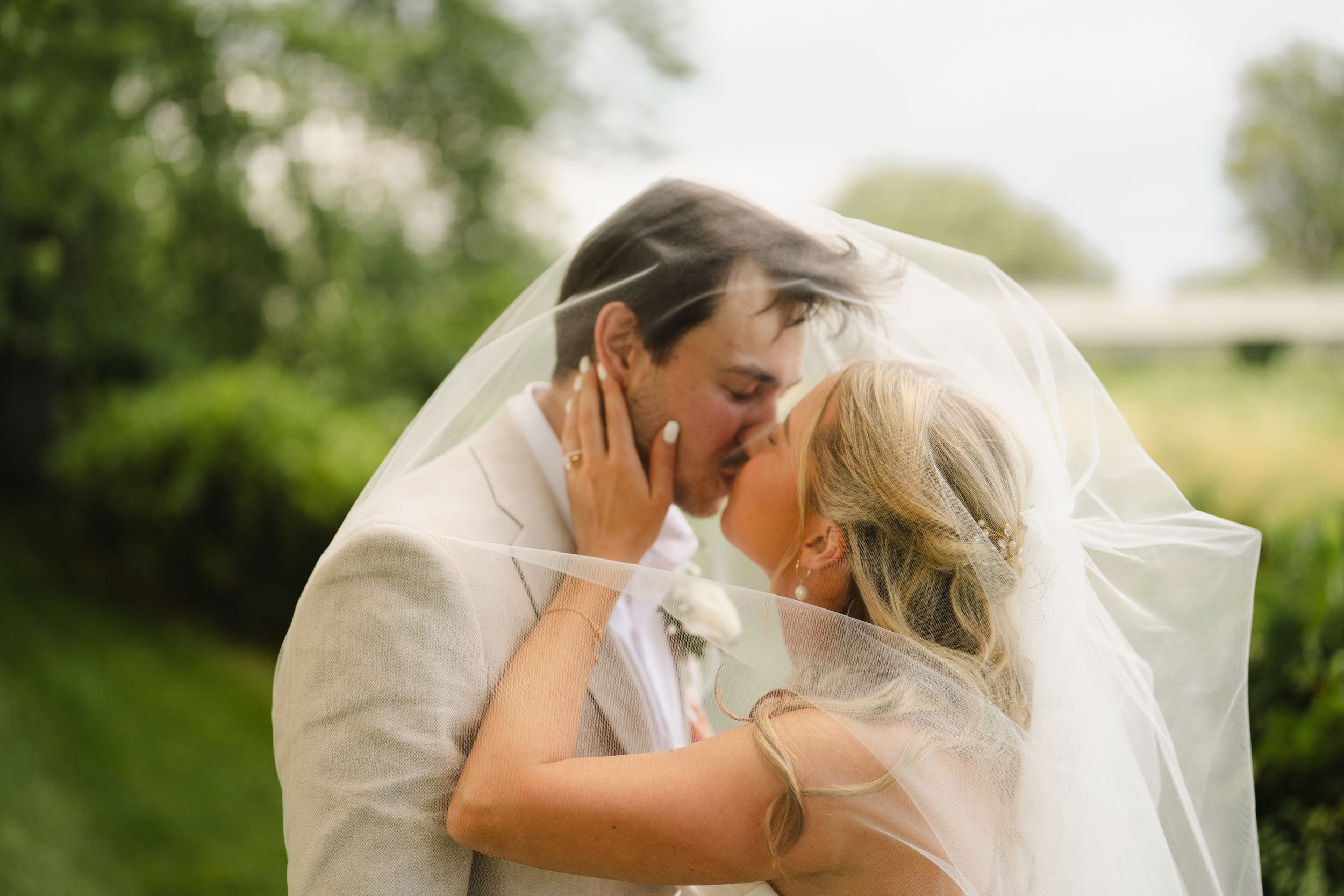 Intimate wedding couple portraits captured outdoors in natural lighting.