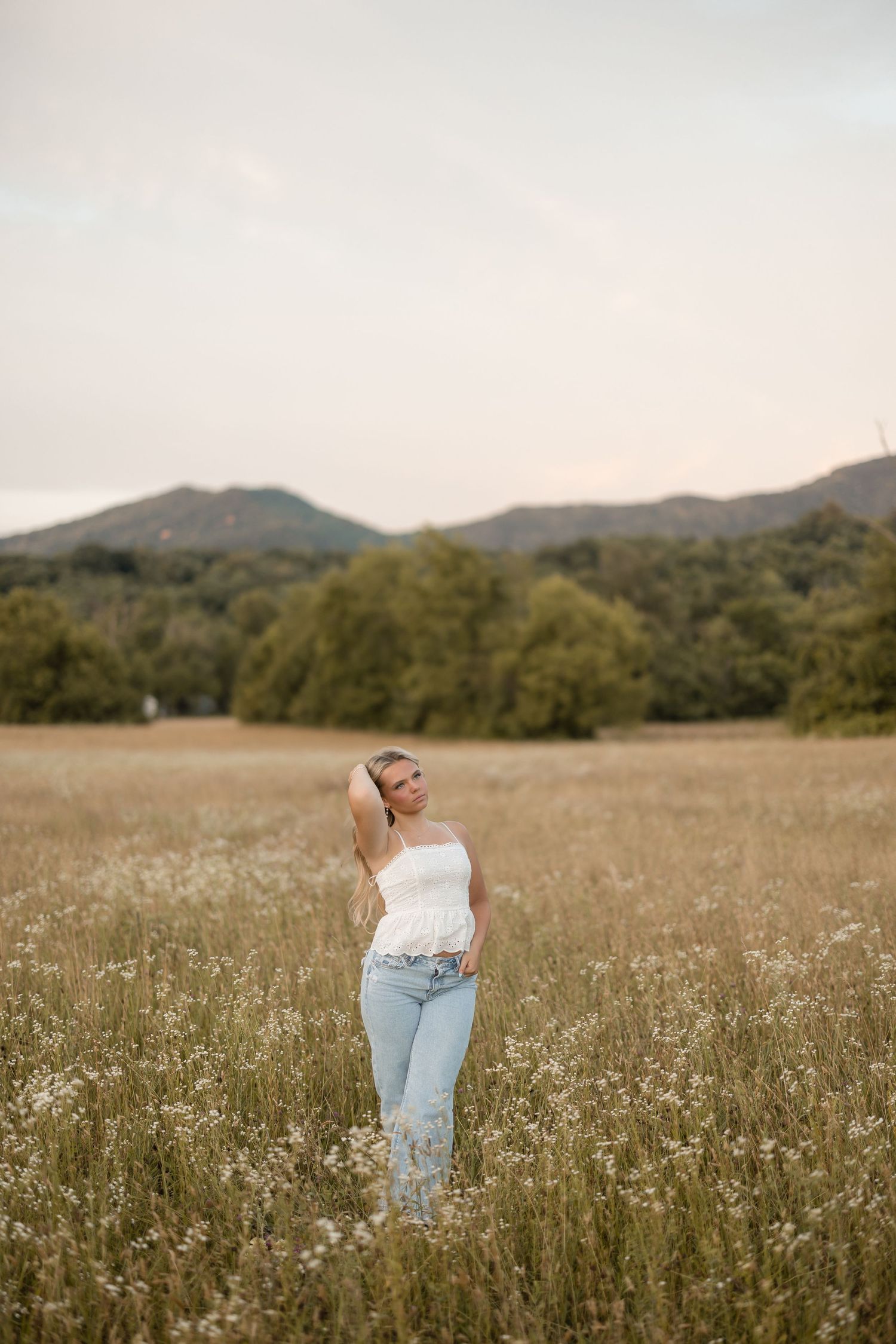Portrait of someone smiling in a lavender field during golden hour sunset.