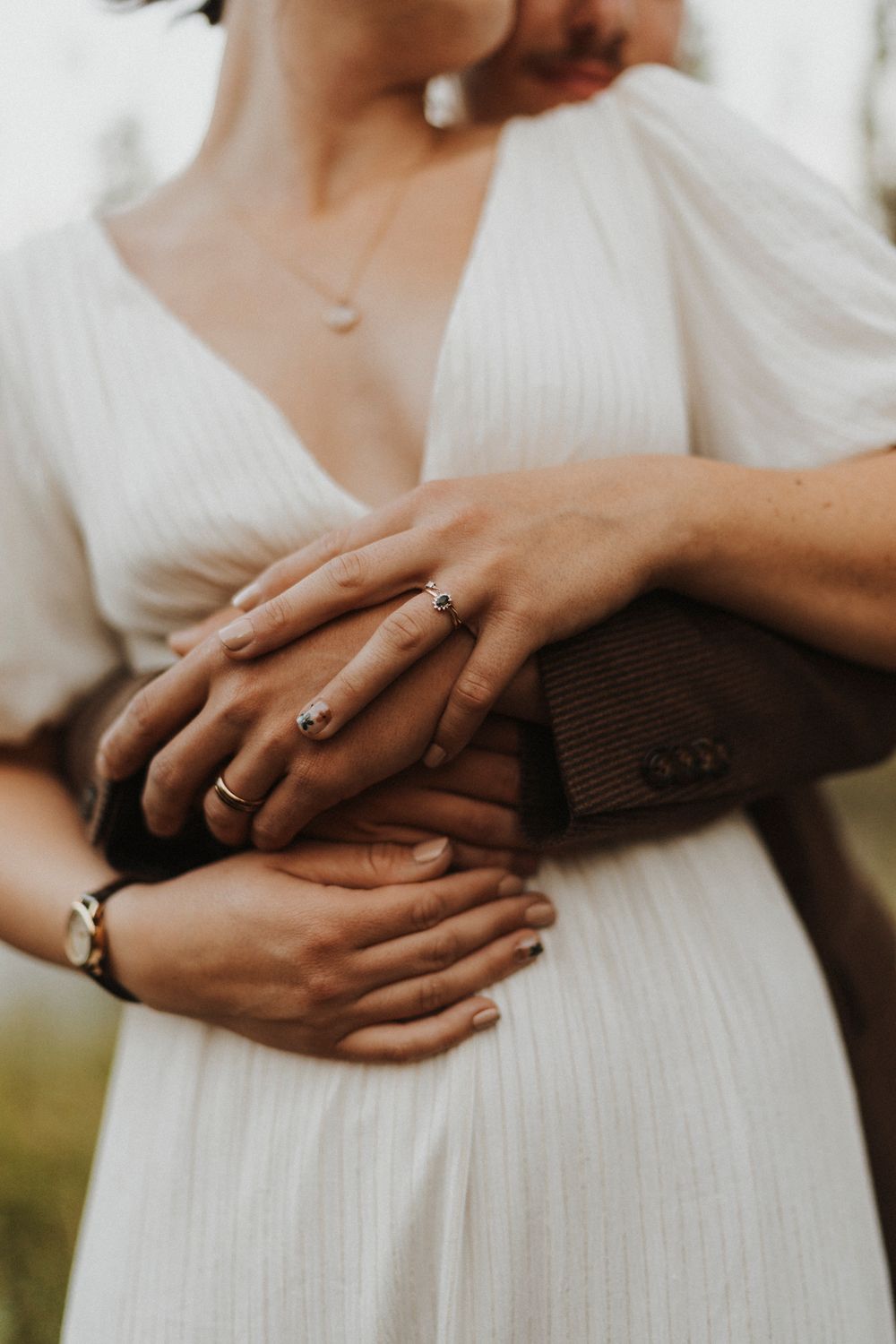 Close-up shots of hands with wedding rings showing tender moments of connection.