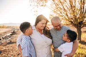 Candid family moment captured during sunset in a rural setting.