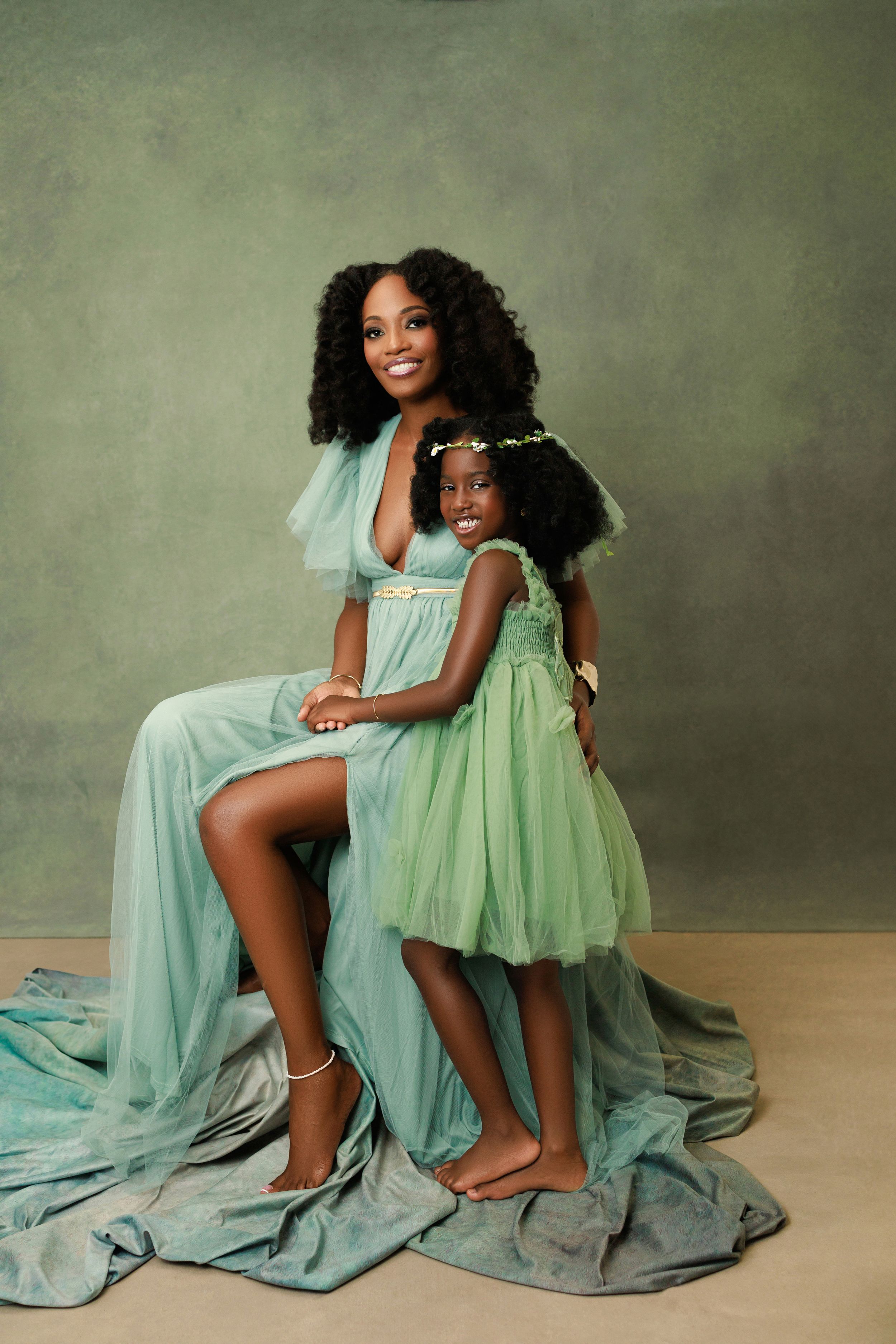 Beautiful posed daughter with her mother, capturing the love and connection on a cozy backdrop.