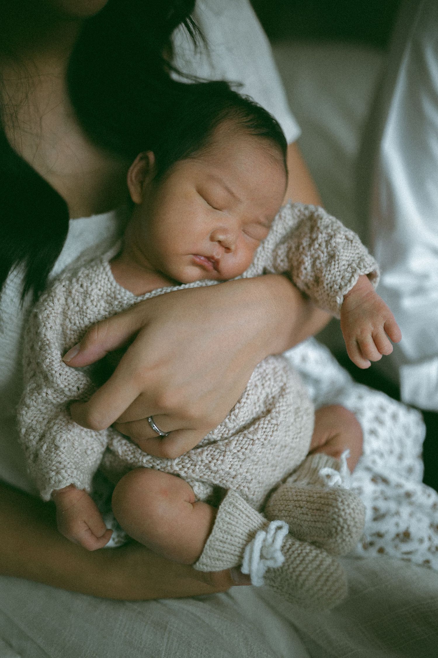 Mother and father holding newborn baby at home in Melbourne