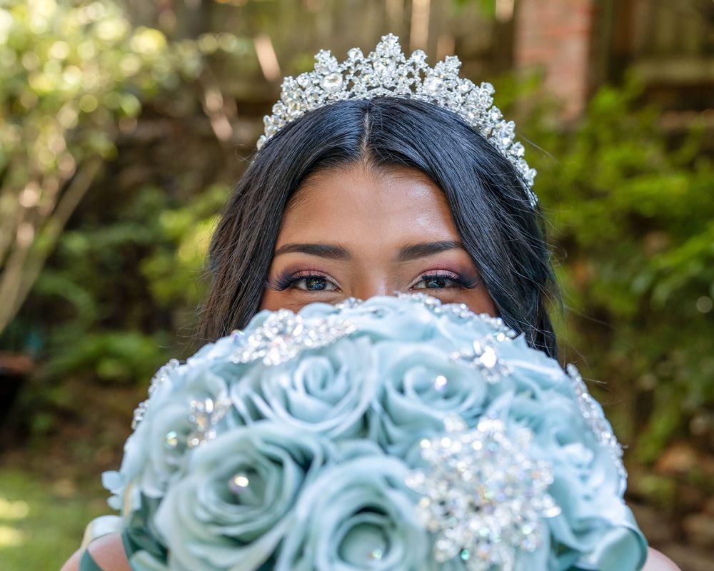 princess looking over blue floral bouquet