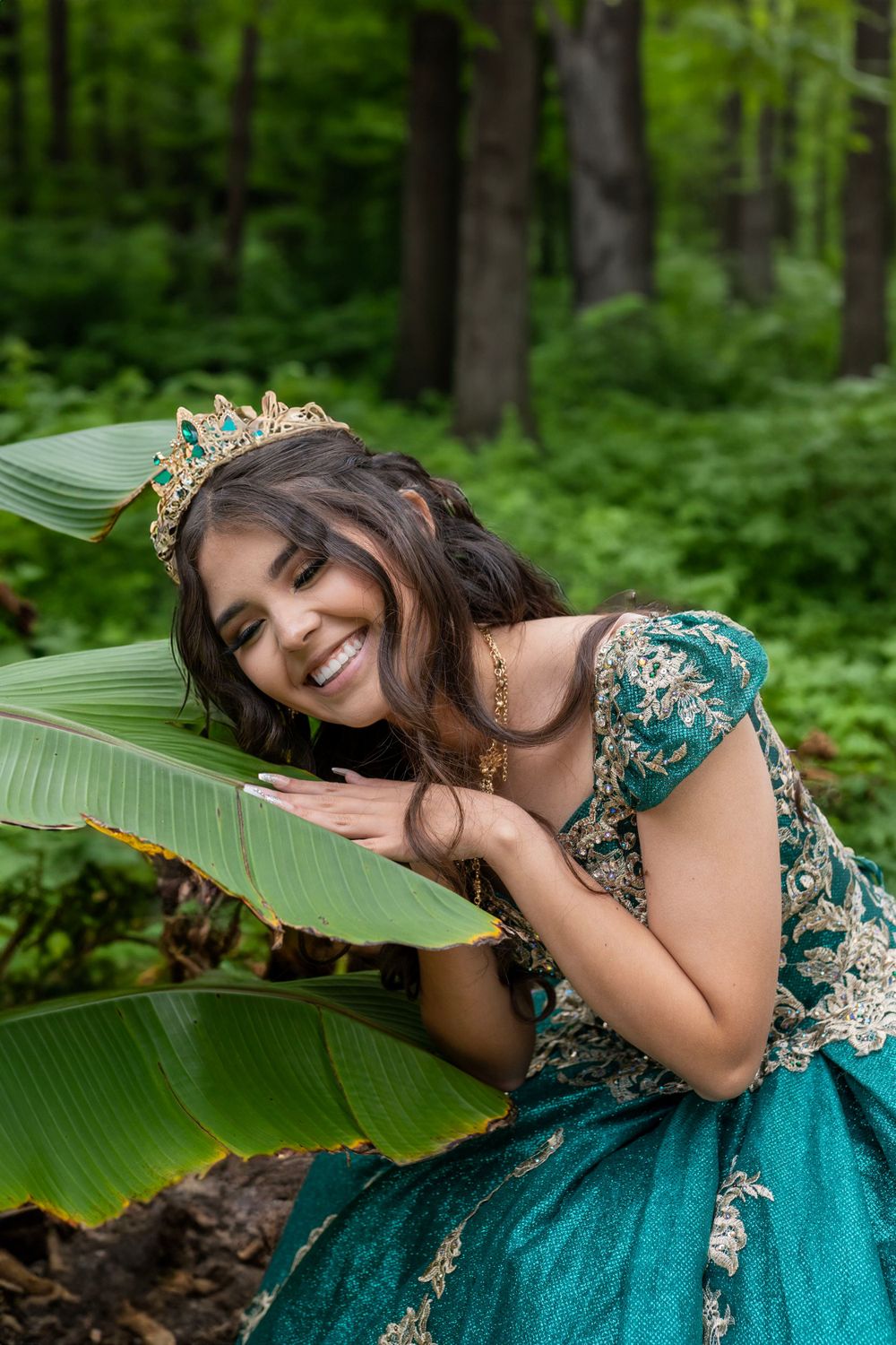 princess holding giant leaf smiling in enchanted forest