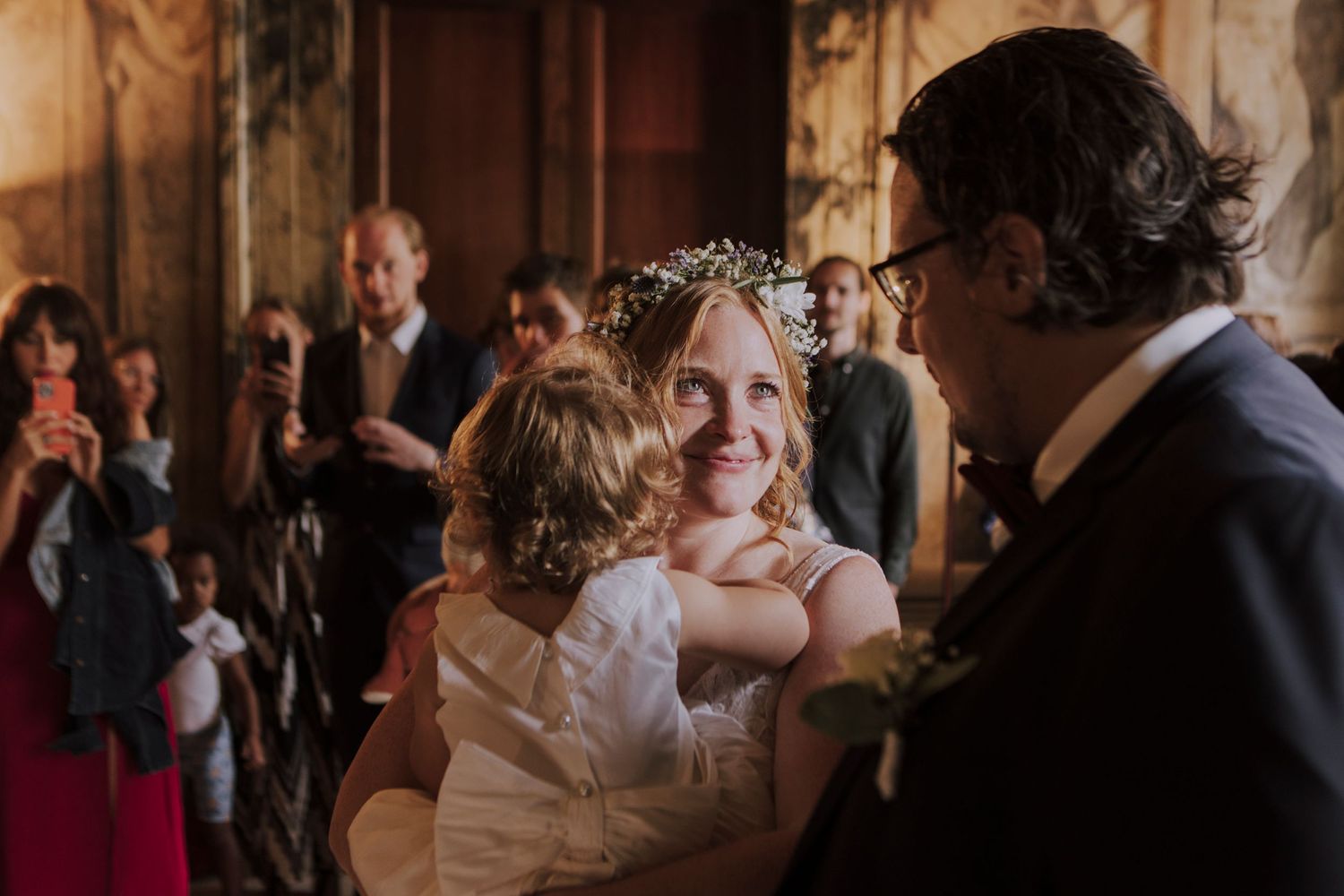 Joyful celebration during a wedding reception in an ornately decorated historic venue.