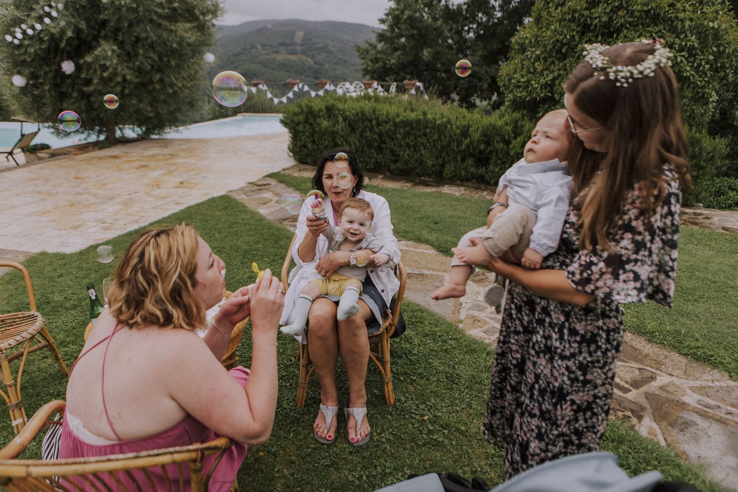 A group enjoys blowing bubbles together during an outdoor gathering.