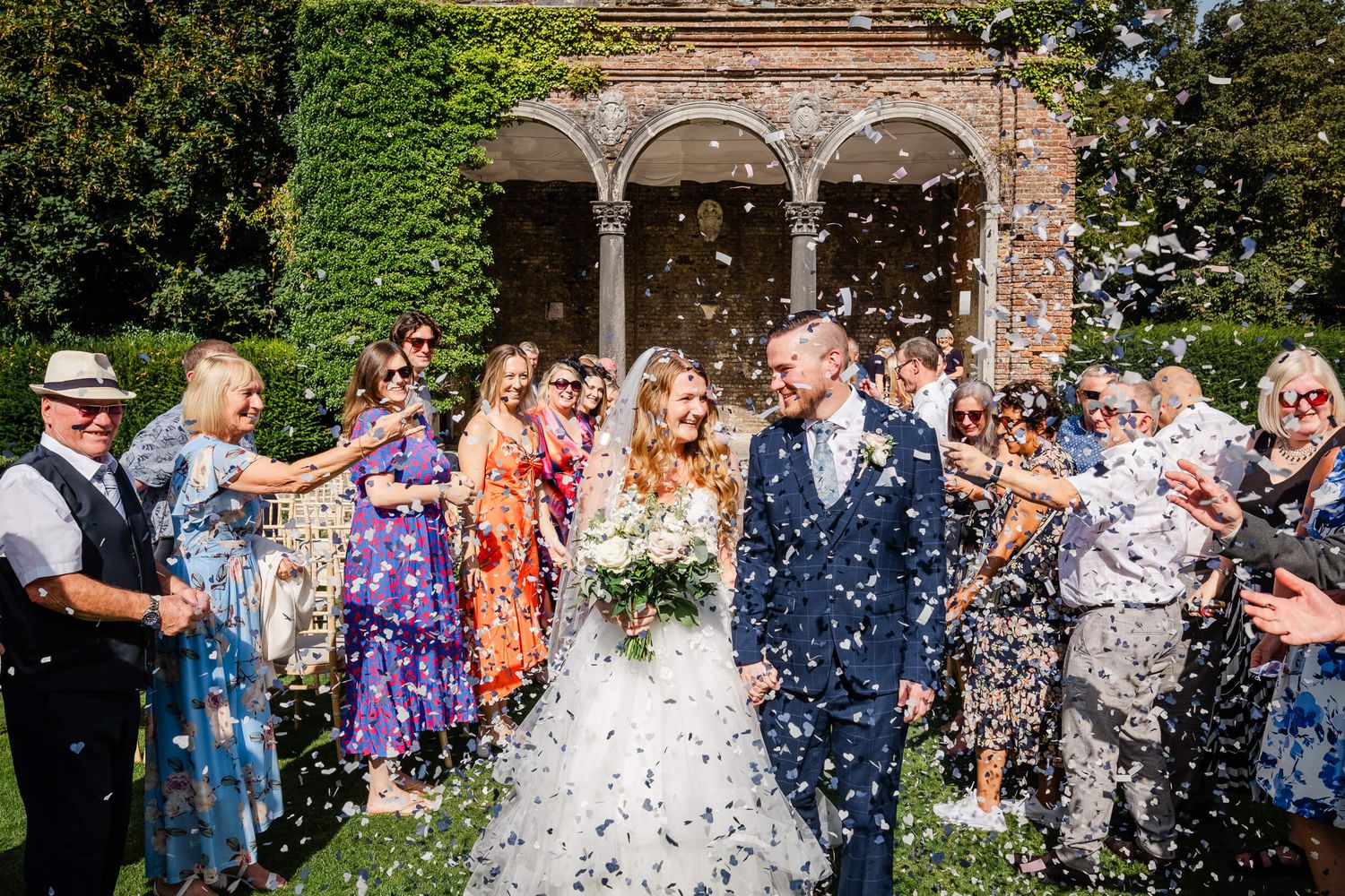Kent Wedding Photographer Broome Park Wedding bride and groom in confetti