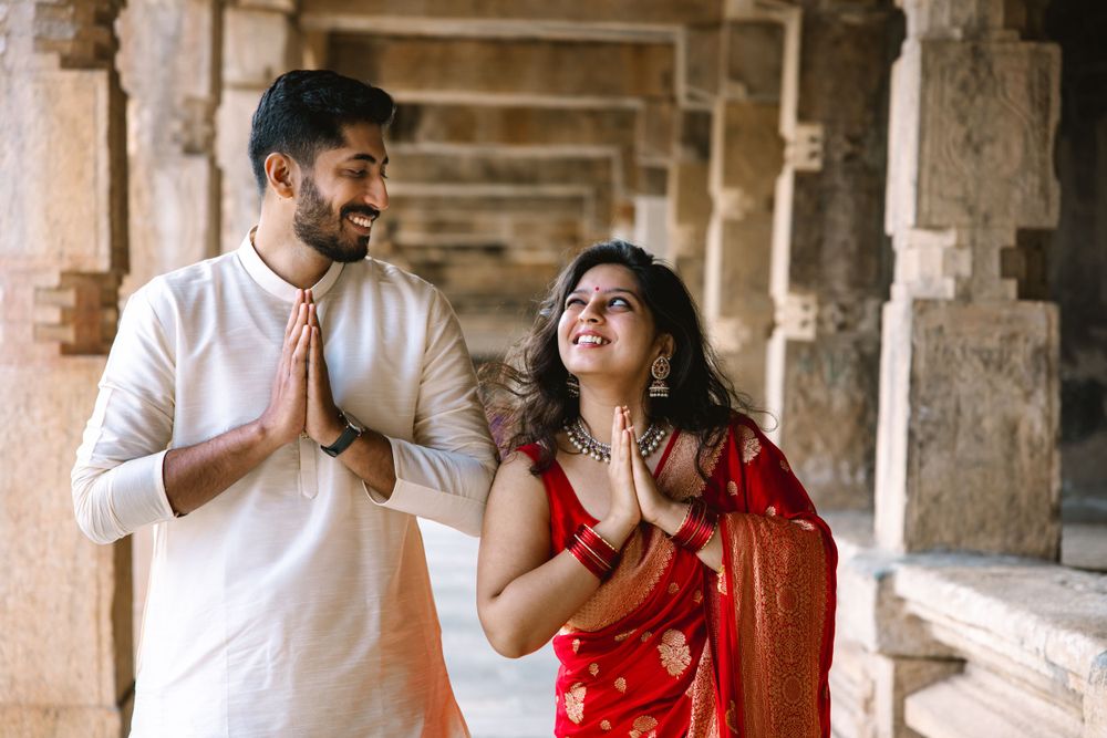A romantic moment captured in a historic stone corridor with natural lighting.