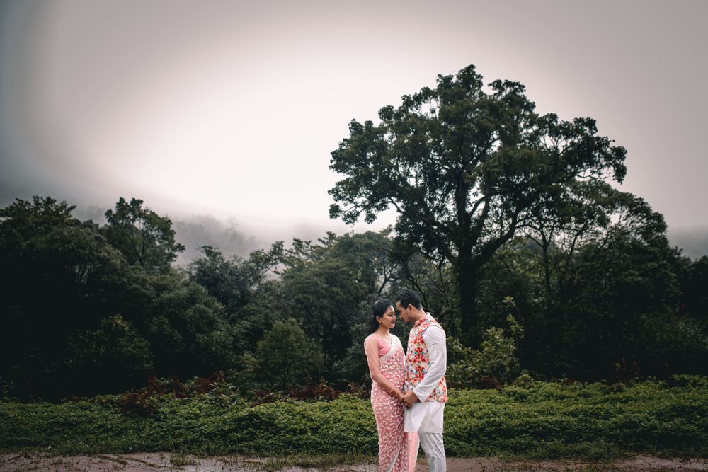 Romantic couple photoshoot in a misty garden landscape with temple architecture.