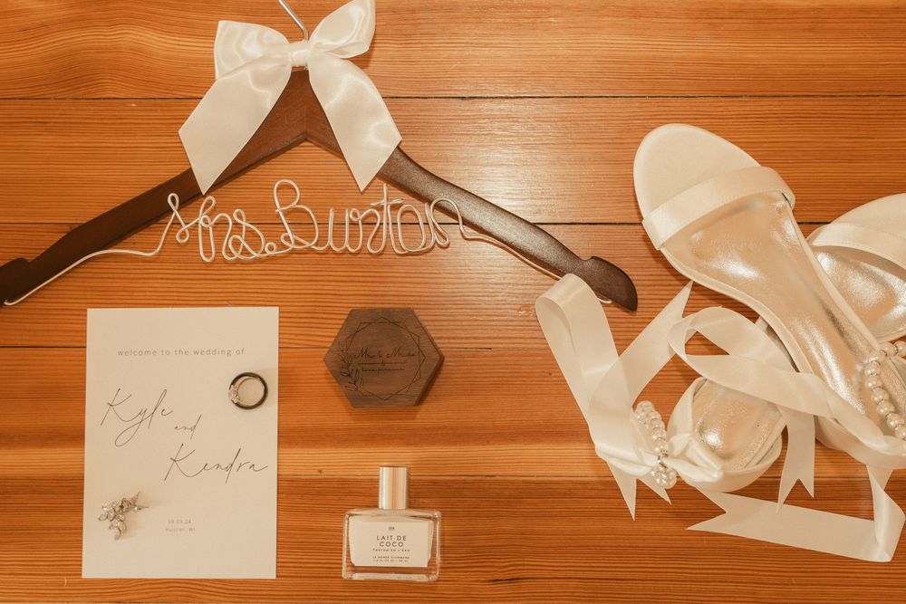 White satin ribbons and bows arranged on a wooden surface for wedding decor and accessories.