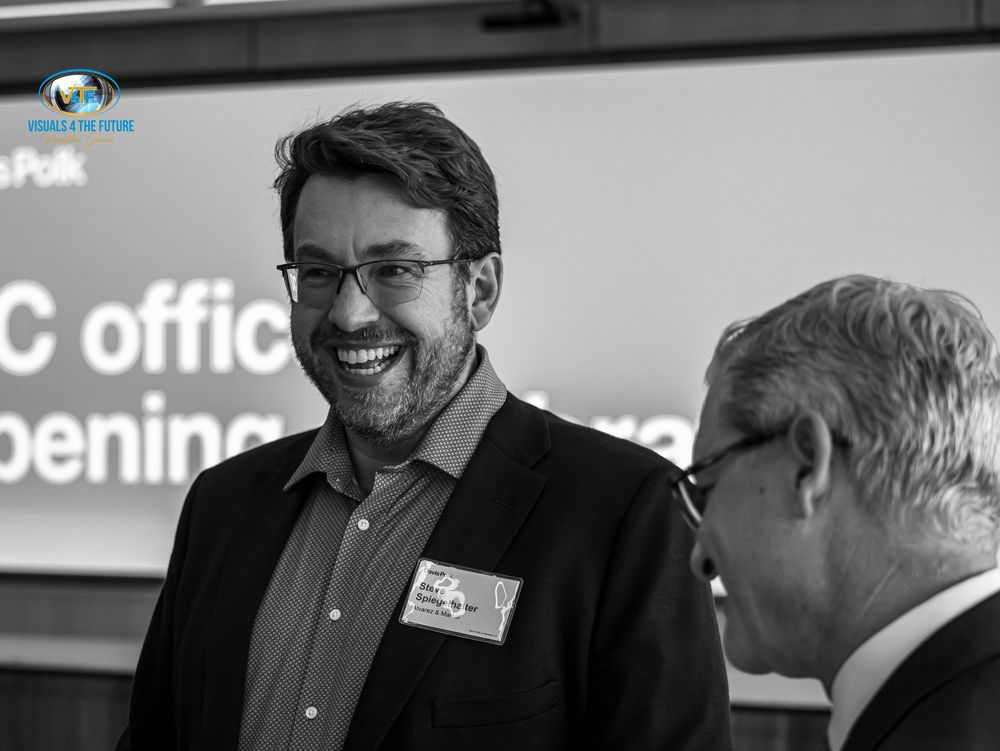 Business professionals engaged in conversation during a corporate networking event.