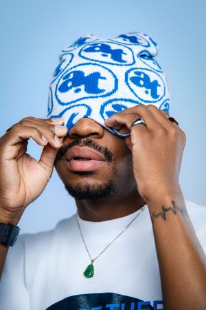 A sequence of photos showing someone adjusting a blue and white patterned durag against a light background.