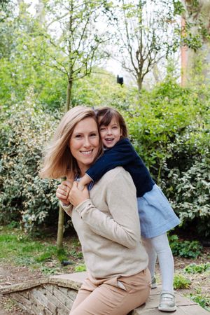 Mum and daughter in a park in Zurich during their Zurich family photography session. Zurich photographer