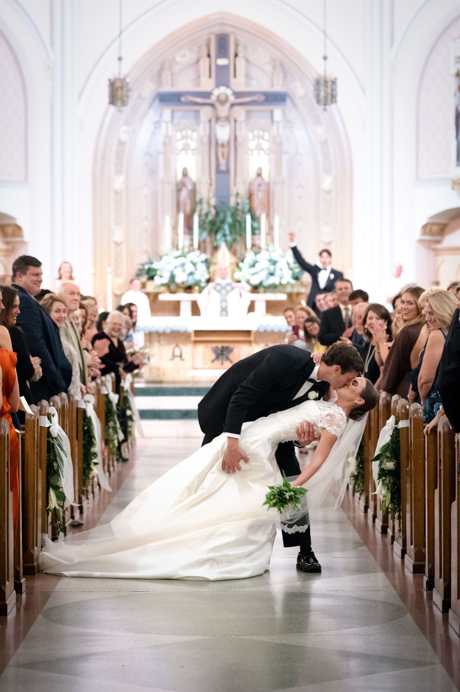 Dramatic wedding ceremony sequence in a grand cathedral with decorated pews and floral arrangements.