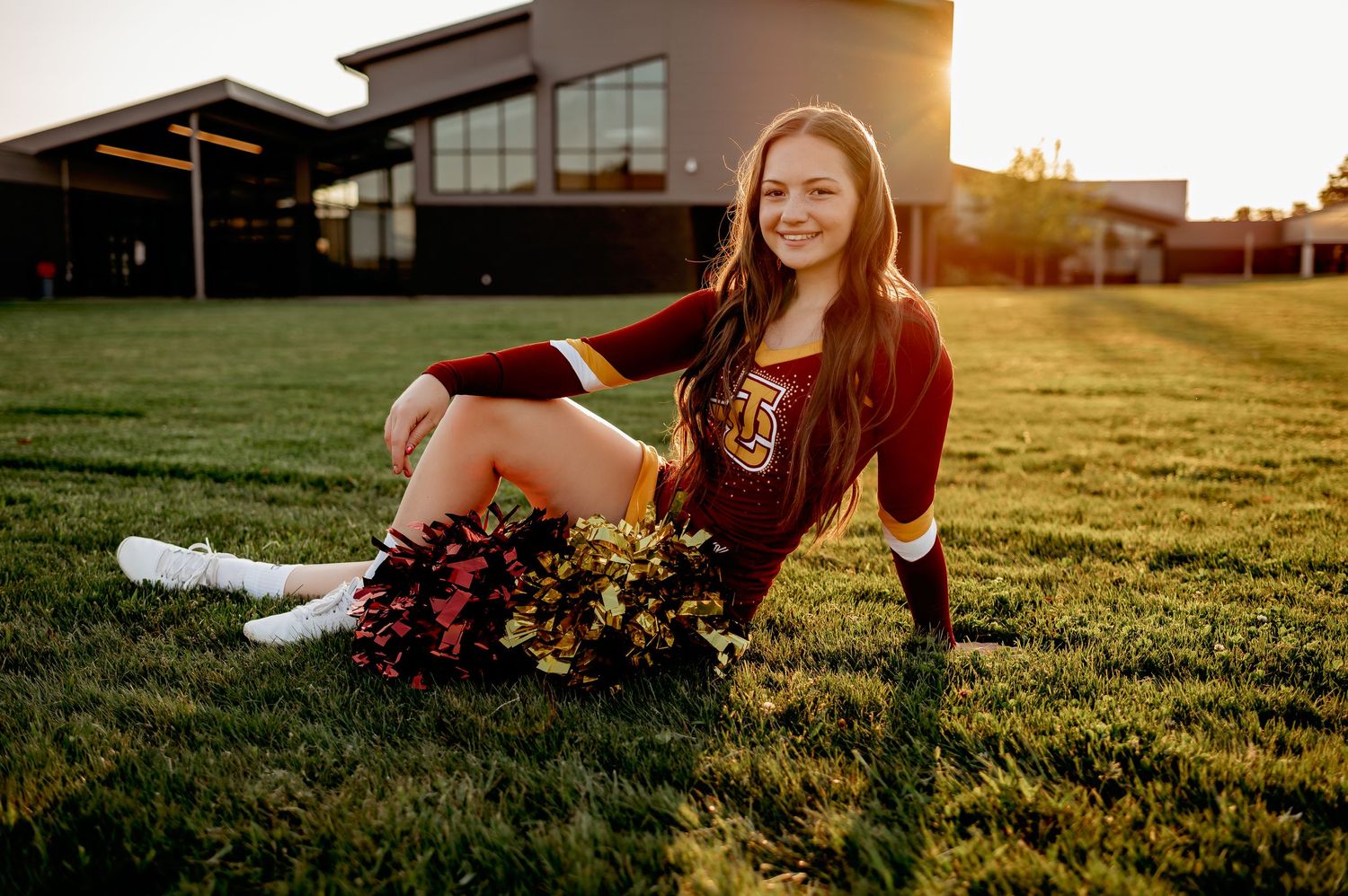 Person lounging in grass field during sunset golden hour photography.