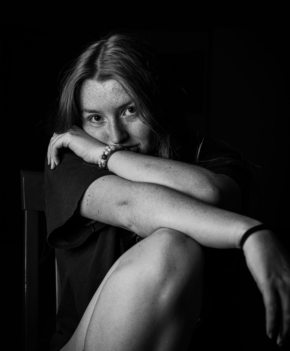 Dramatic black and white self-portrait series showing a person hiding their face in shadow.