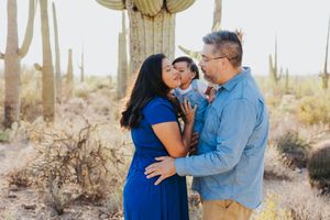 Intimate family portrait in a desert setting with saguaro cacti.