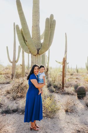Beautiful family portraits taken in natural desert environment with iconic saguaro cacti.