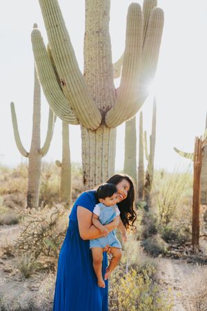 Candid family moments captured during sunset in a saguaro-filled desert setting.