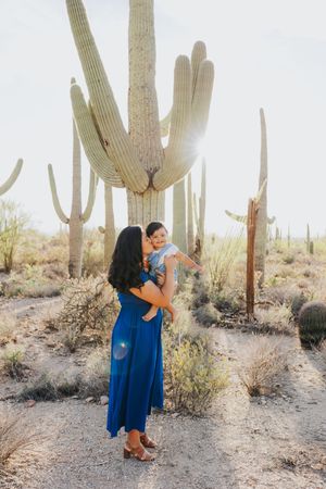 Natural family photography in Arizona's desert landscape with towering saguaro cacti.