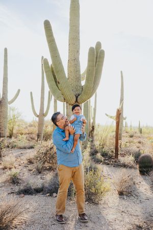 Joyful expressions captured against a backdrop of desert saguaros in natural lighting.