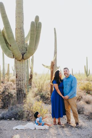 Family portrait session in a serene desert setting surrounded by majestic saguaro cacti.