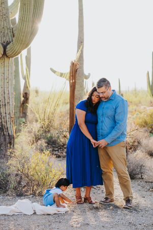 Intimate family moments captured in a desert landscape with towering saguaro cacti.