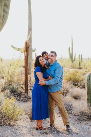 Romantic desert photoshoot featuring tender moments among towering saguaro cacti.
