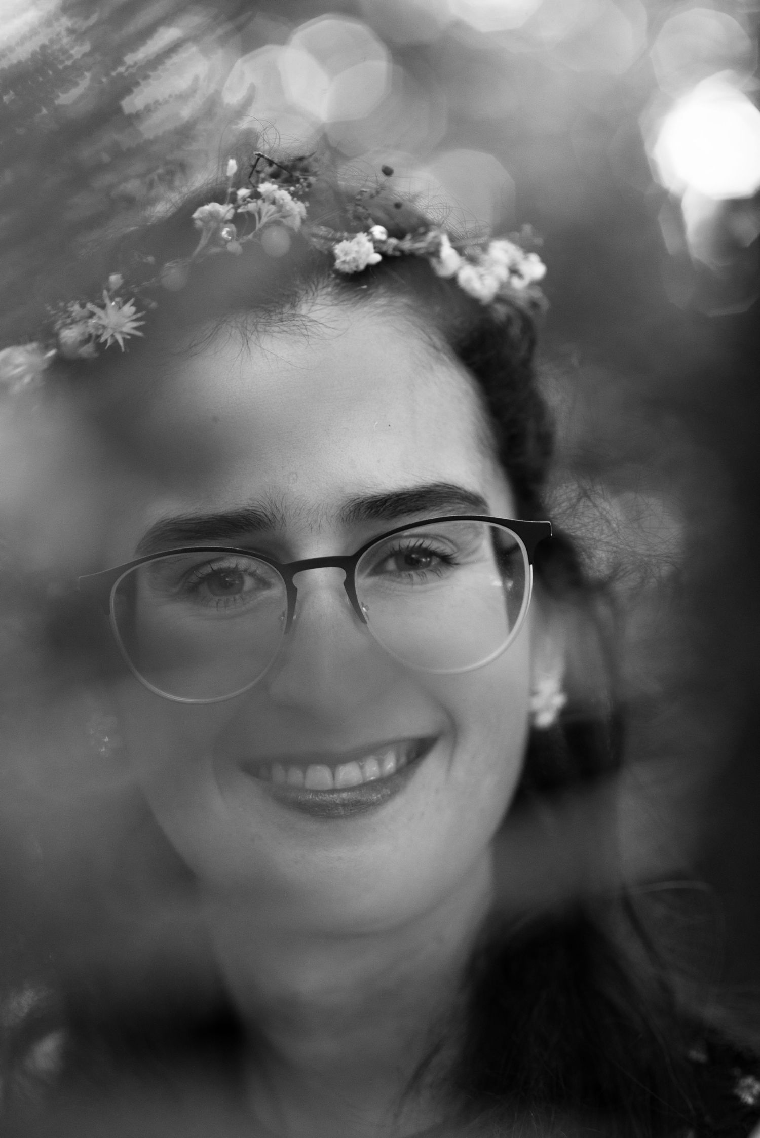 Dreamy black and white portraits with soft bokeh and floral elements.