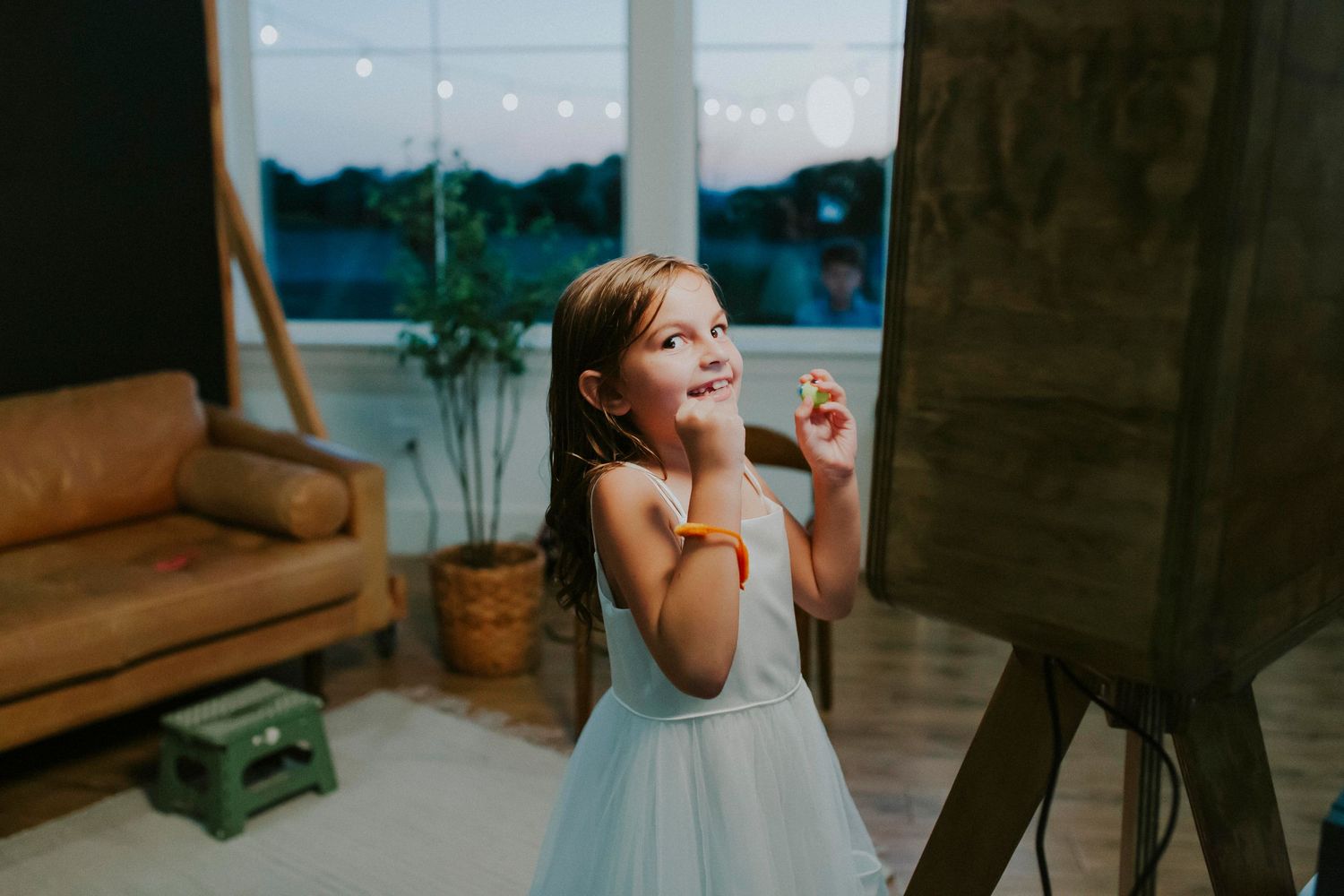 Candid laughing moments captured during indoor photo session with natural lighting.