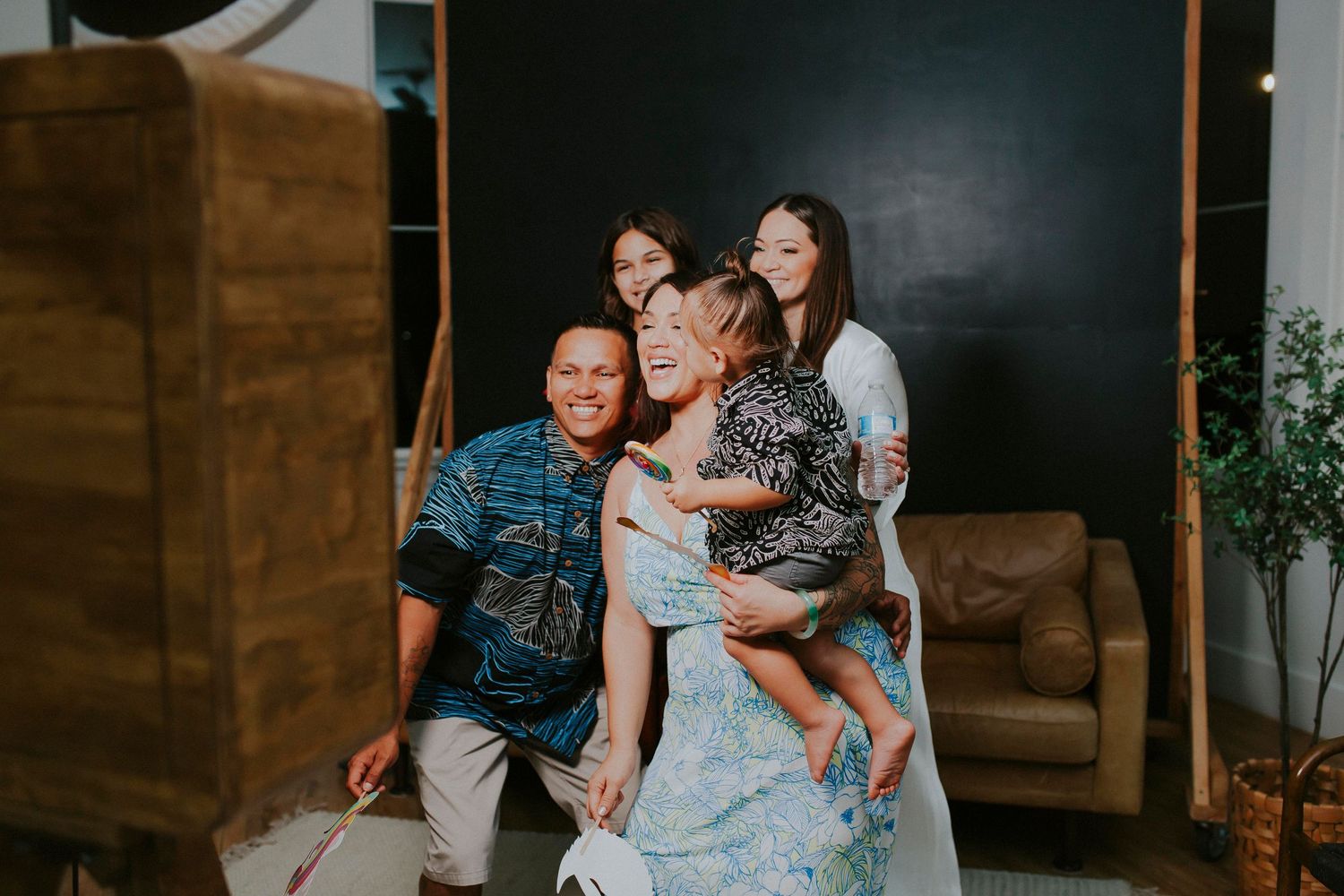 Candid family gathering moment captured in studio with modern rustic decor.