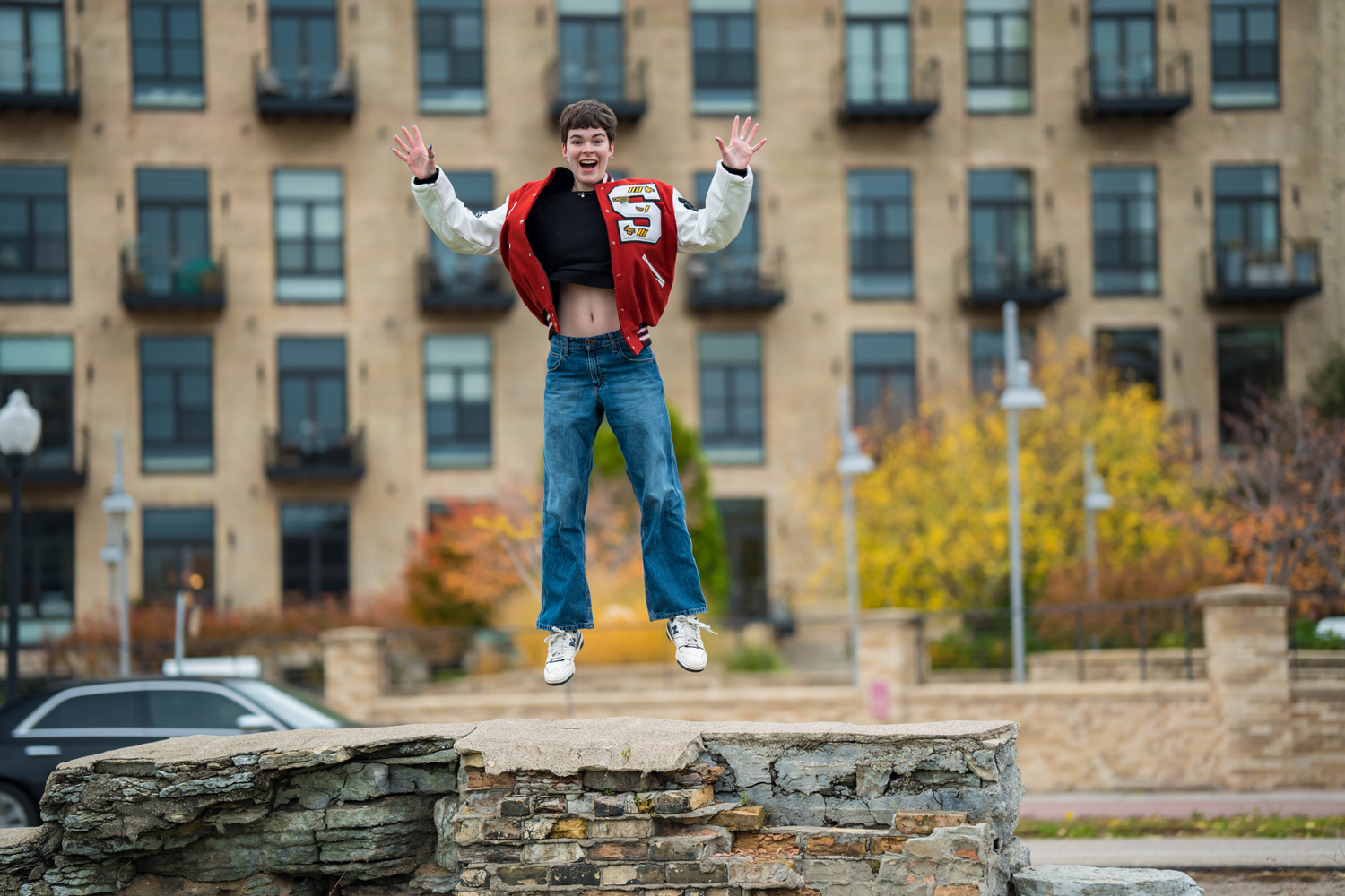 A confident senior poses against a scenic backdrop, ready to take on the world