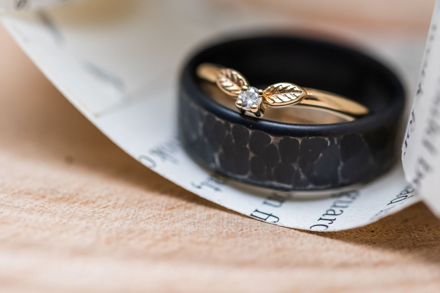 Close-up macro shot of wedding rings with artistic lighting and composition.