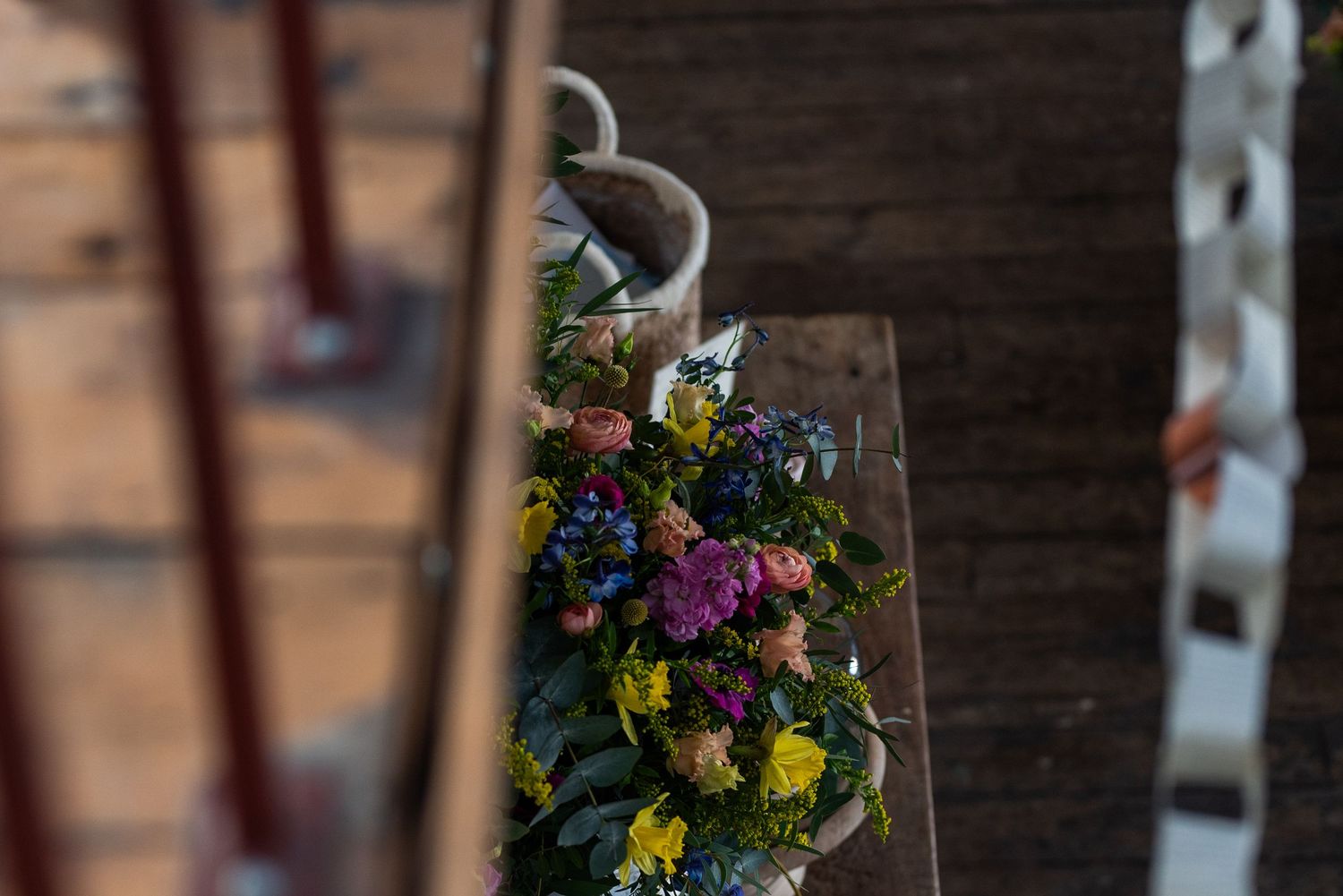 Vibrant spring flowers arranged in bouquets against exposed brick walls.