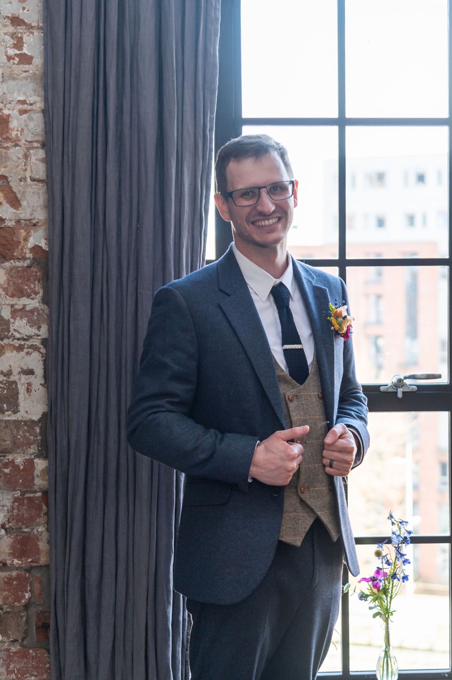 Wedding speech being given in an industrial-style venue with exposed brick walls.