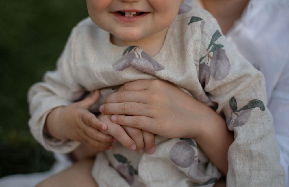 Candid shot showing joyful laughter and genuine emotion outdoors.