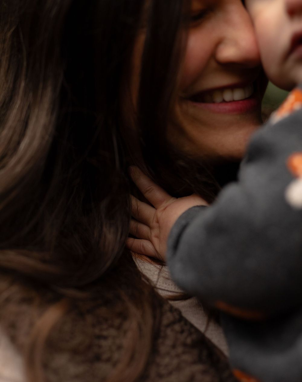 Close-up of a warm smile in soft natural lighting creating an intimate and candid portrait.