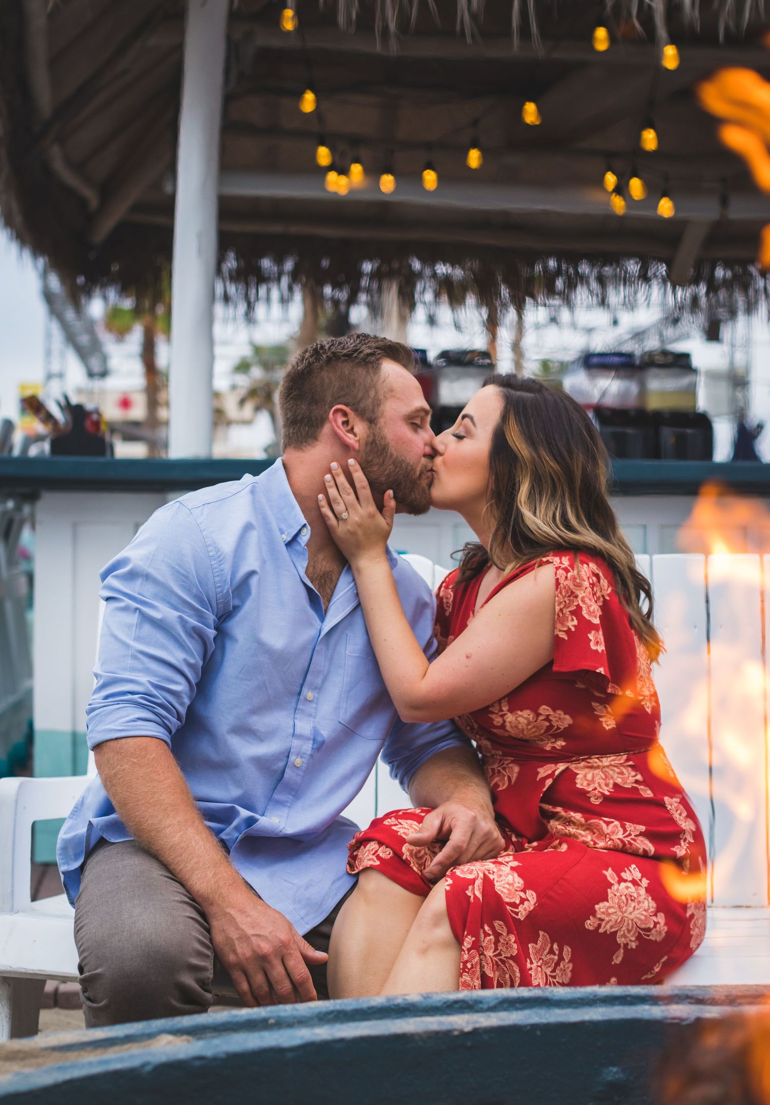 couple kissing by the fireplace at beachhouse in san diego